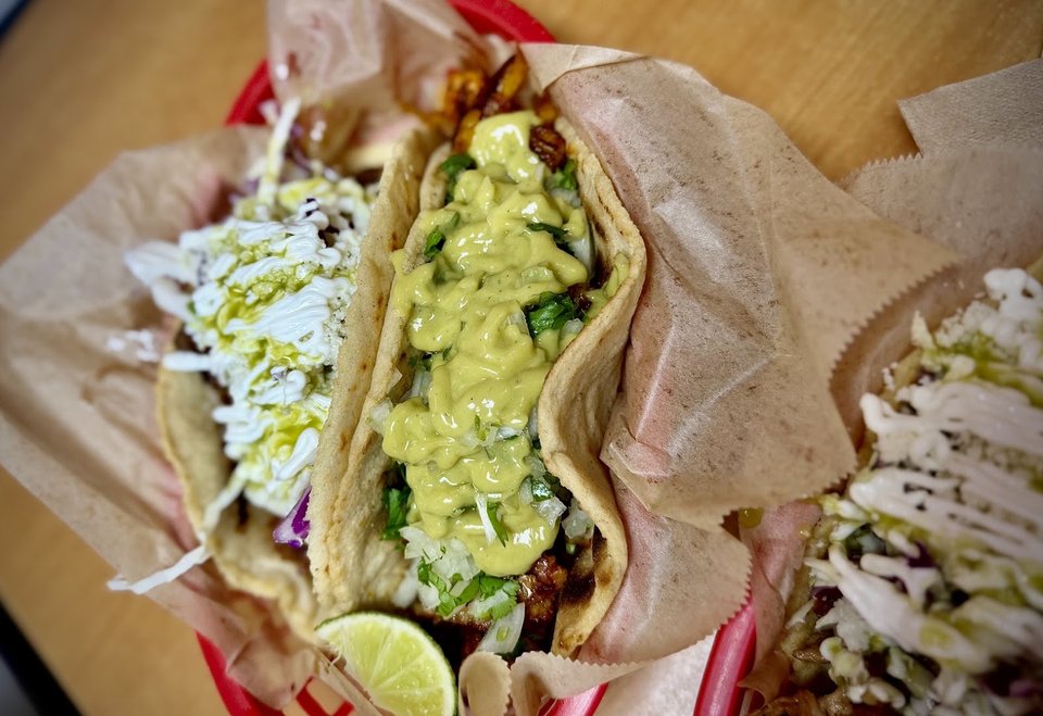 Colorful tacos on a casual restaurant table.